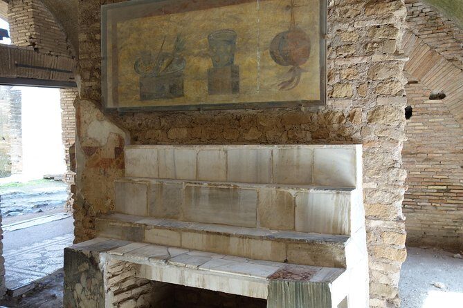Ancient Ostia Antica Semi-Private Day Trip from Rome by Train with Guide - Amphitheater, forum buildings, temples, and the city’s civic heartbeat