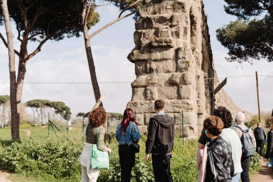 Rome: Appian Way, Aqueducts, and Catacombs Tour - Parco degli Acquedotti: standing under Roman aqueducts